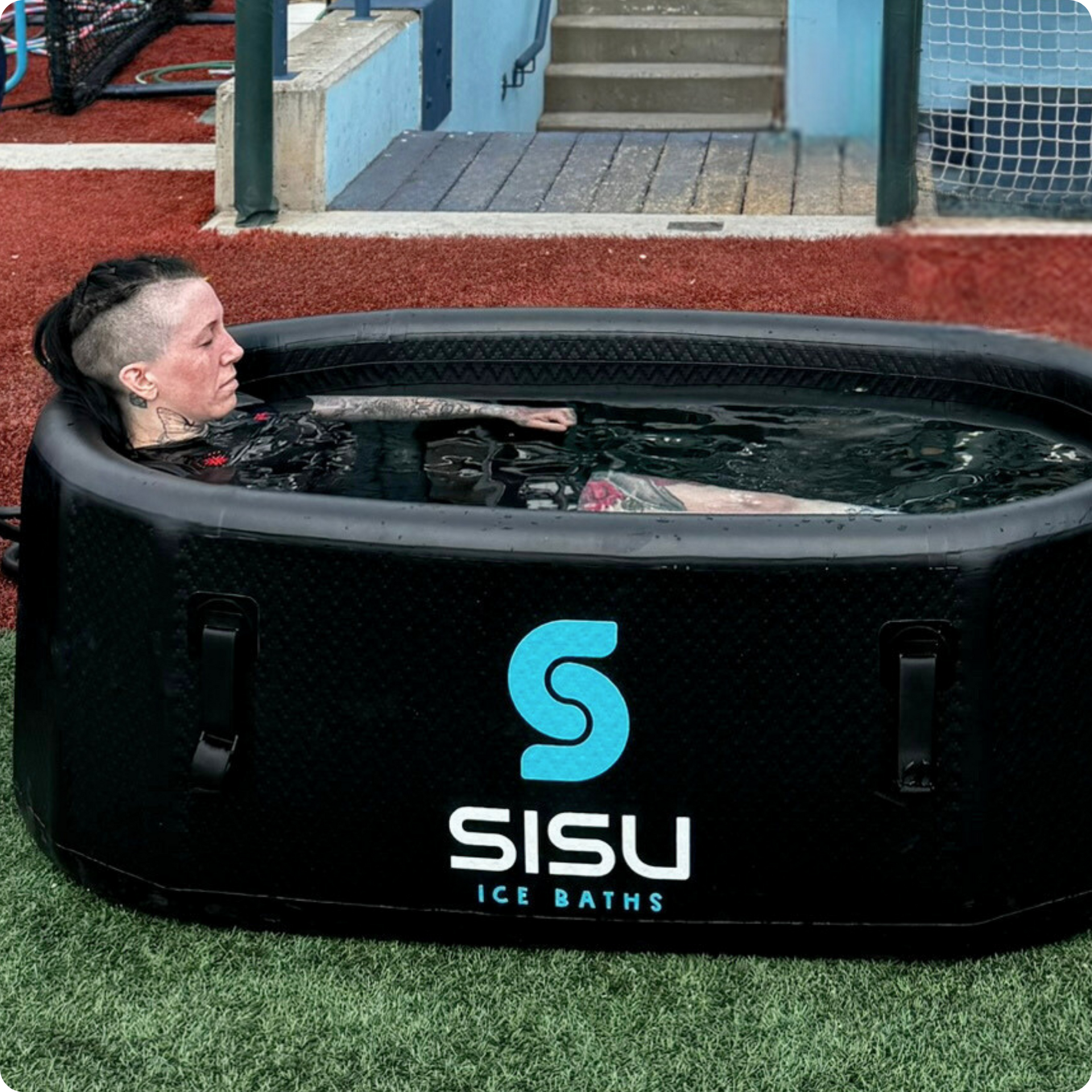 A lady immerses herself in the Helsinki Professional Cold Plunge Tub for cold therapy.