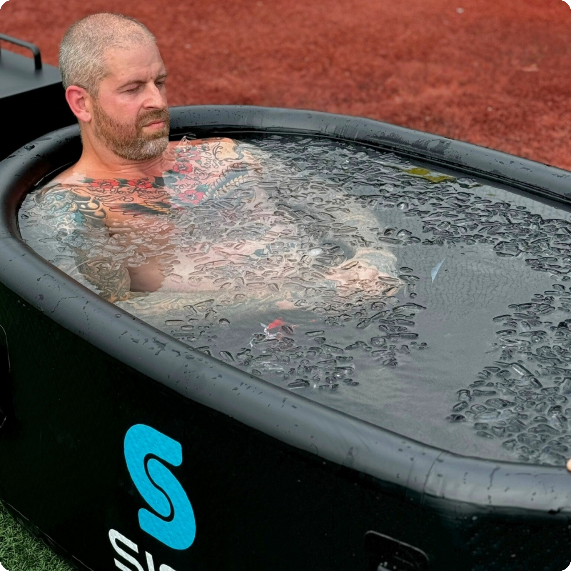 A man immerses himself in the Helsinki Professional Cold Plunge Tub for cold therapy.