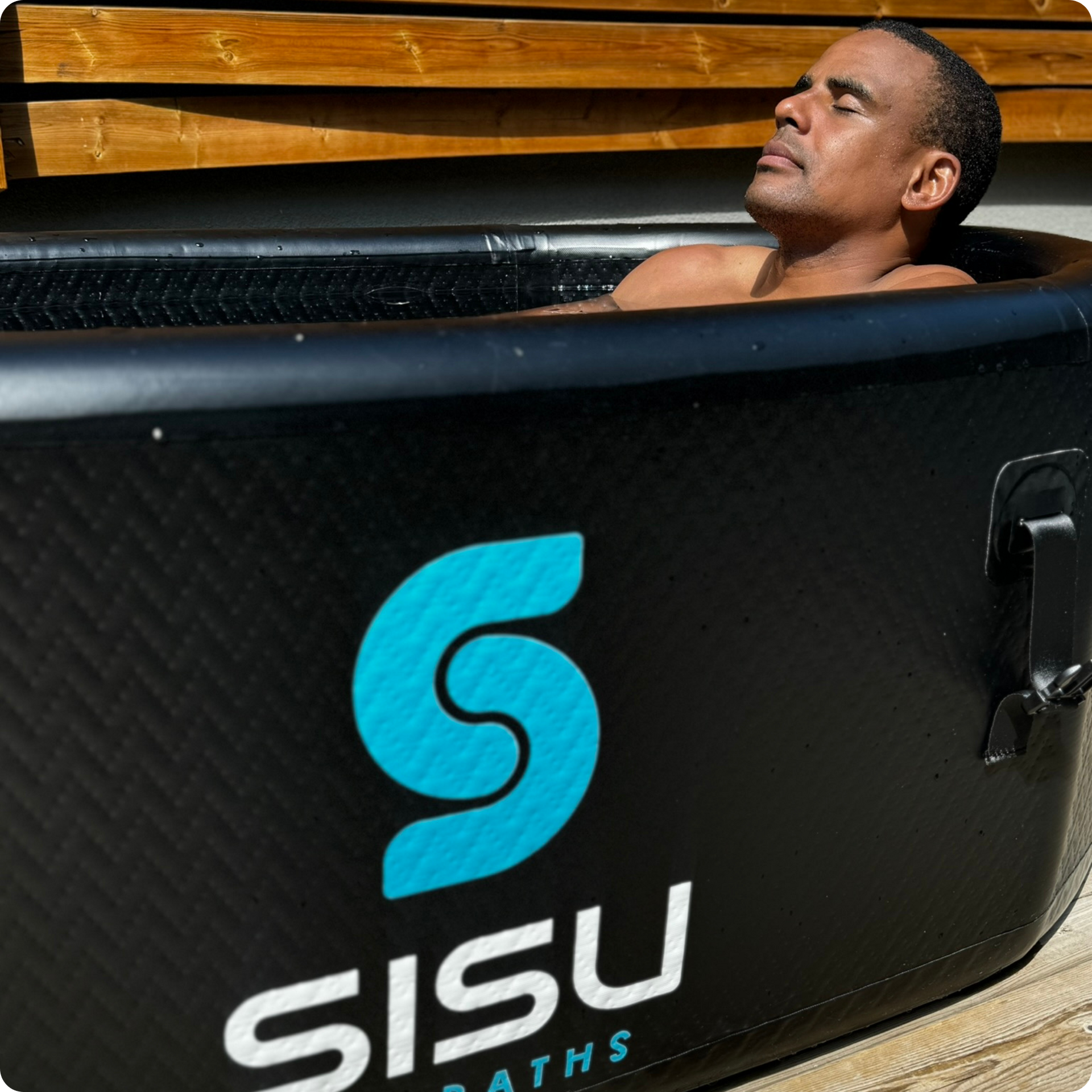 Andre Belibi immerses himself in the Helsinki Professional Cold Plunge Tub for cold therapy.