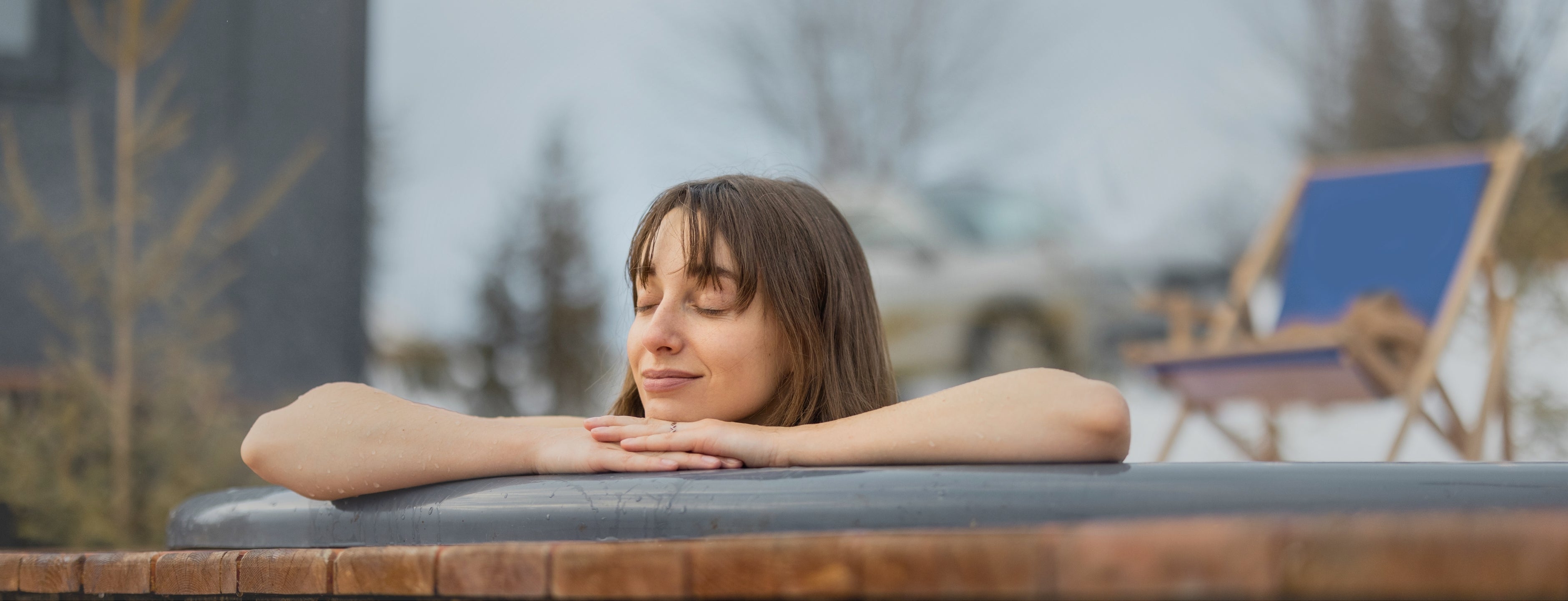 A lady immerses himself in the ice water for cold therapy.