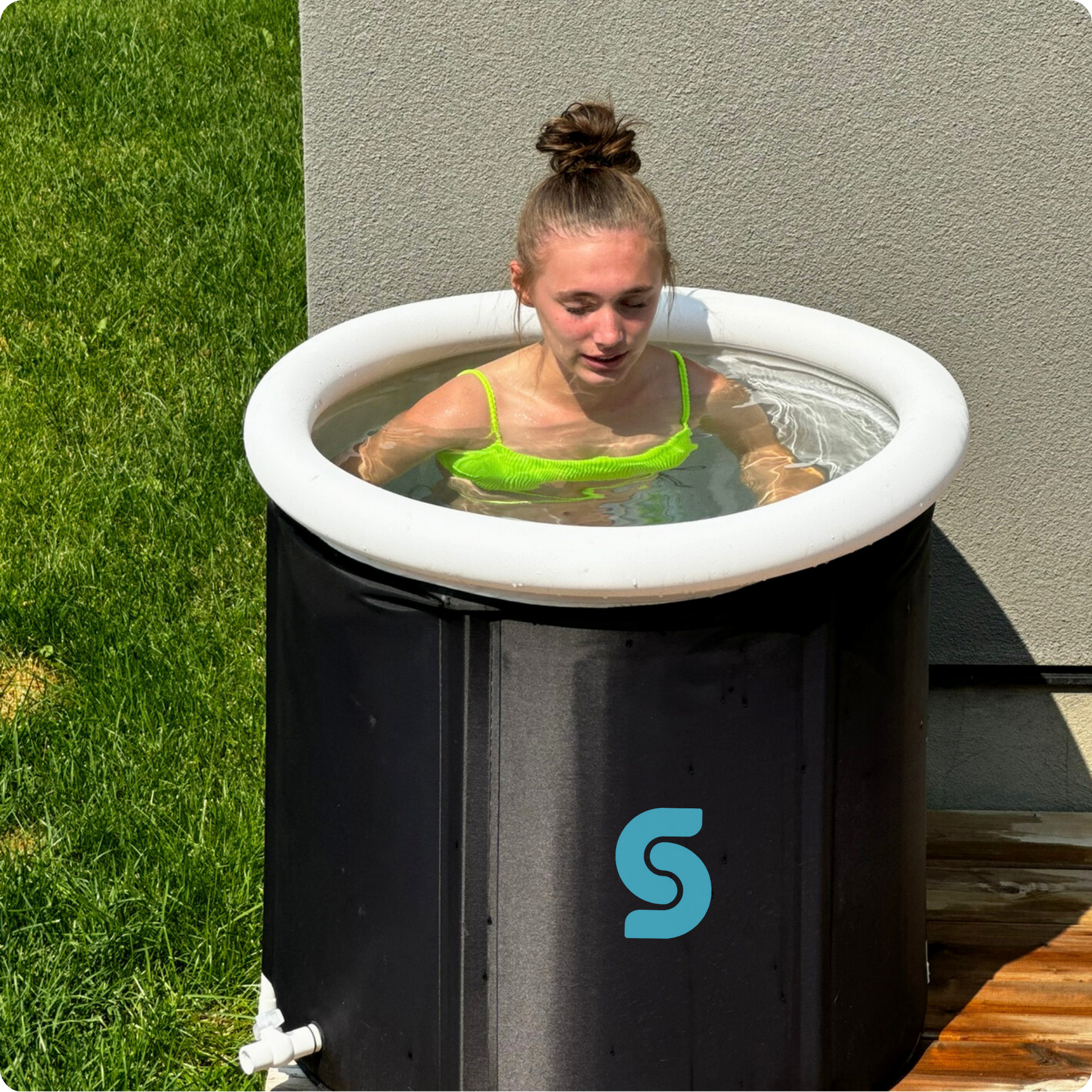 A kid immerses herself in the Kotka Cold Pod for cold therapy.