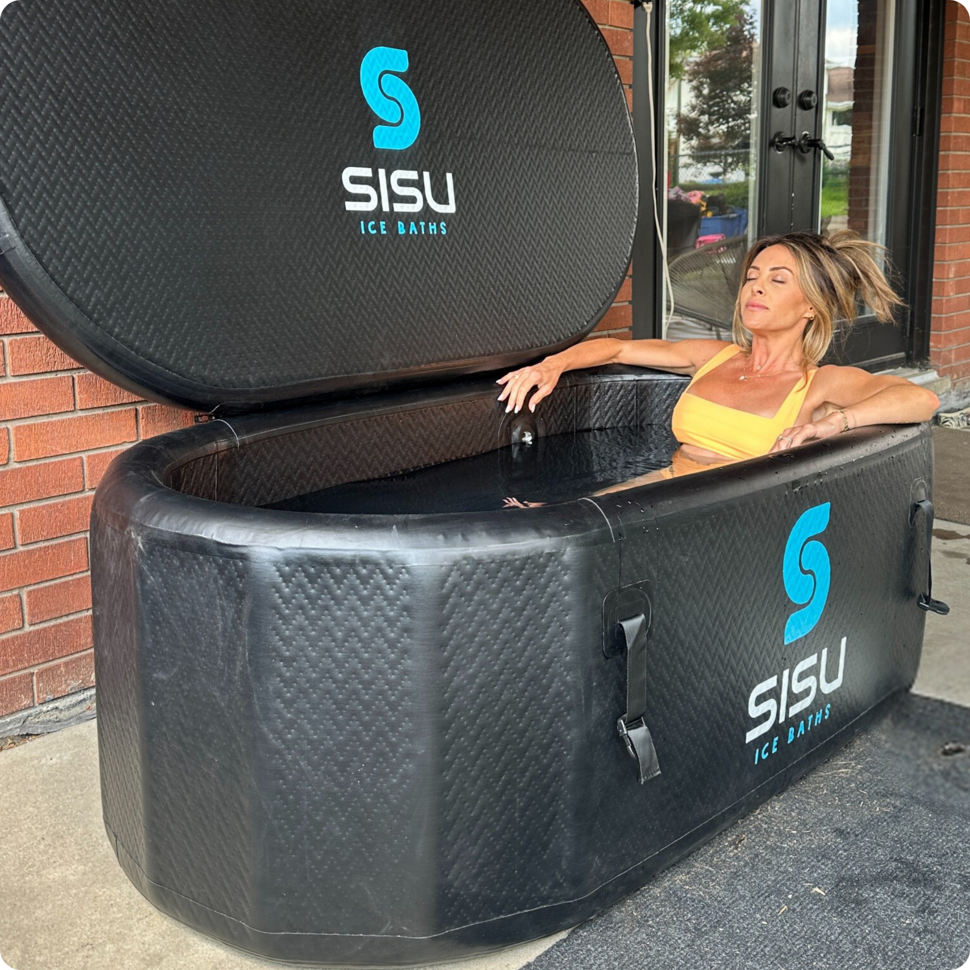 A lady immerses himself in the Helsinki Professional Cold Plunge Tub for cold therapy.